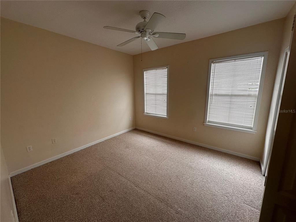 709 Bloom Street, Unit 240 Celebration, FL 34747 - Photo 9 of 17 an empty room with windows and fan