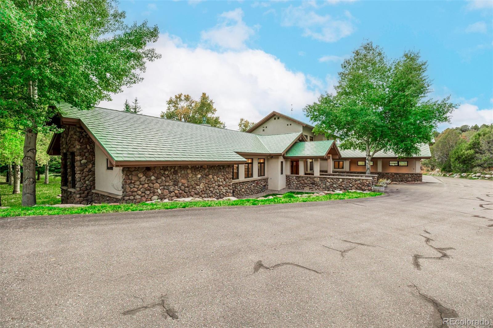 983 Beard Creek Road Edwards, CO 81632 - Photo 18 of 23 a front view of a house with a yard and a garage