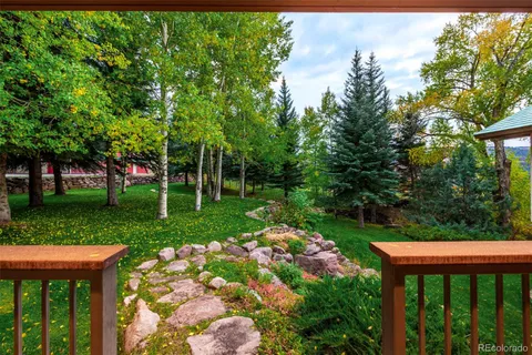 a view of a wooden deck with a yard