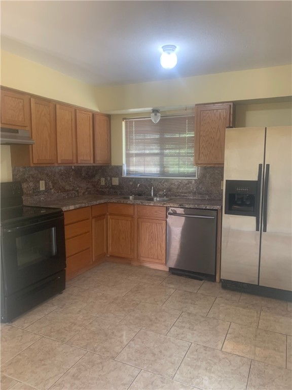2829 South Sea Drive Corpus Christi, TX 78418 - Photo 2 of 10 a kitchen with stainless steel appliances granite countertop a stove a sink and a refrigerator