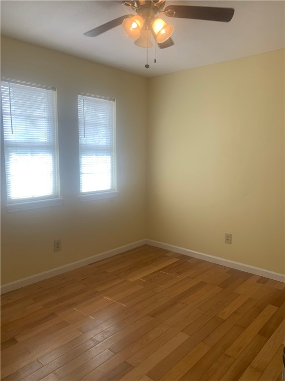 2829 South Sea Drive Corpus Christi, TX 78418 - Photo 10 of 10 an empty room with wooden floor and windows
