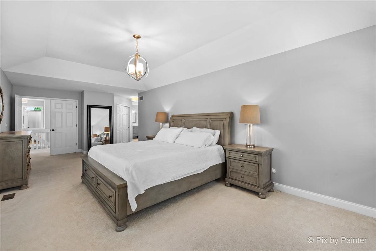 2 Shadow Creek Court Lake In The Hills, IL 60156 - Photo 19 of 44 a spacious bedroom with a bed a chandelier and dresser