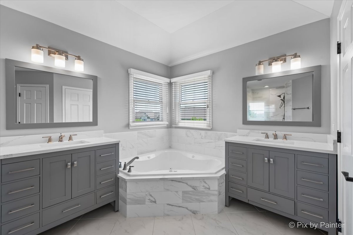 2 Shadow Creek Court Lake In The Hills, IL 60156 - Photo 20 of 44 a bathroom with a tub sink double vanity and mirror