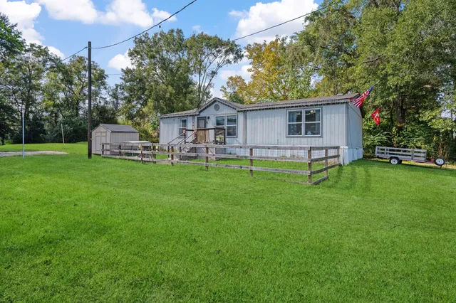 a view of a house with a backyard