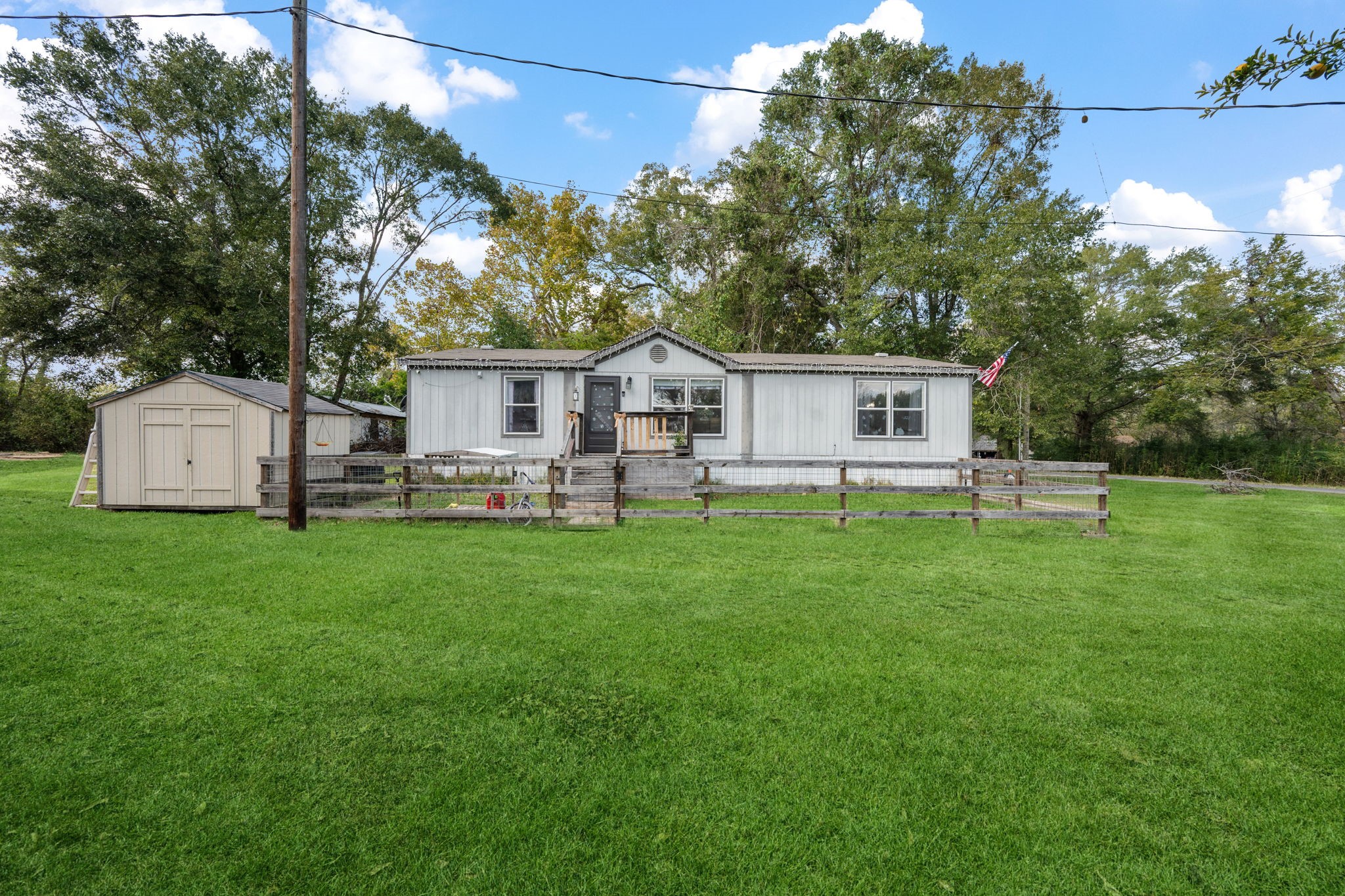 440 River Road Goodrich, TX 77335 - Photo 2 of 18 a front view of a house with a garden and trees