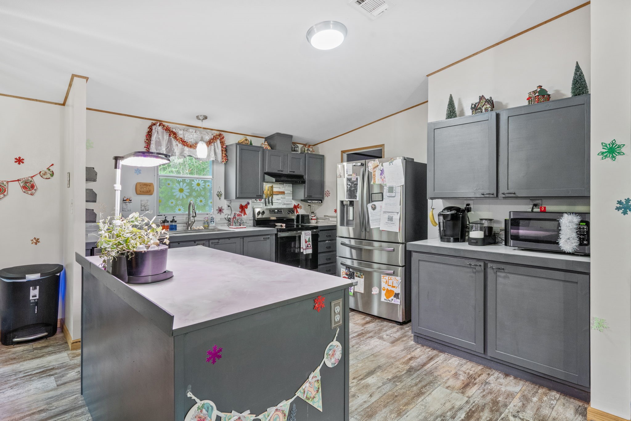 440 River Road Goodrich, TX 77335 - Photo 9 of 18 a kitchen with stainless steel appliances kitchen island granite countertop a refrigerator a stove top oven a sink and dishwasher