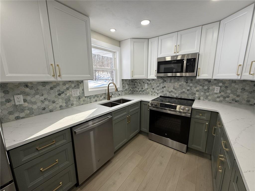315 Vaneal Road Washington, PA 15301 - Photo 10 of 26 a kitchen with stainless steel appliances granite countertop a sink stove microwave and cabinets