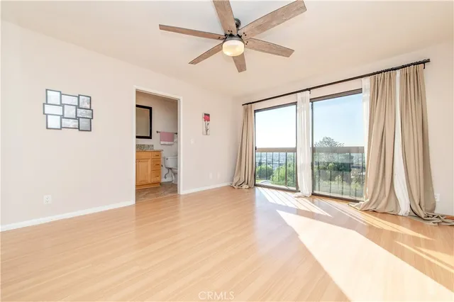 a bathroom with a granite countertop sink a toilet and a mirror