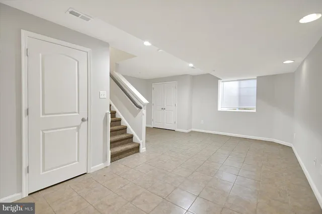 a view of an empty room with stairs