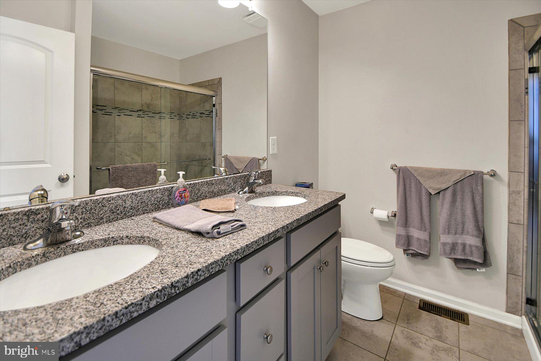 3600 Jacob Stout Road, Unit 3 Doylestown, PA 18902 - Photo 25 of 33 a bathroom with a granite countertop sink and a mirror