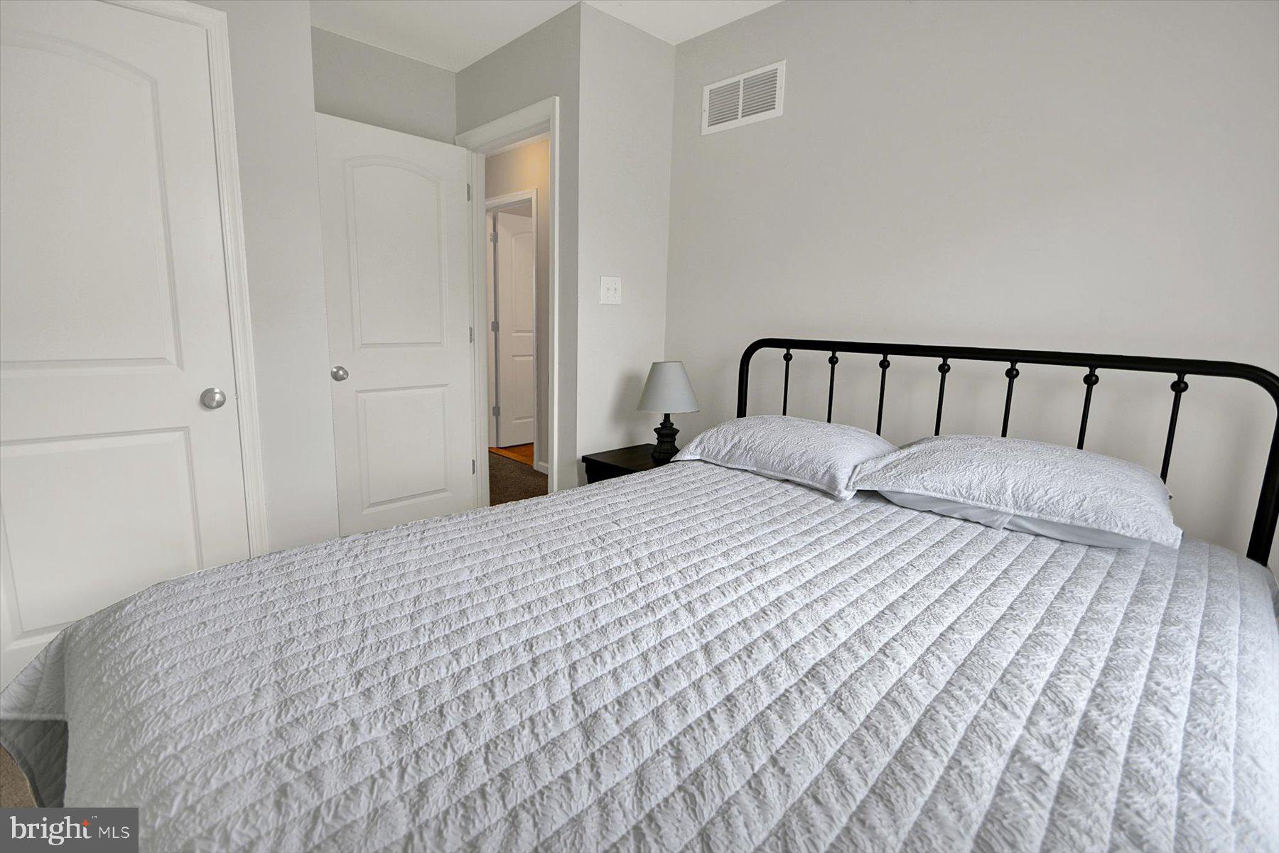 3600 Jacob Stout Road, Unit 3 Doylestown, PA 18902 - Photo 31 of 33 a large bed in a bedroom with a white comforter and pillows