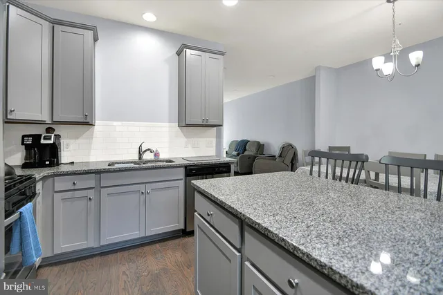 a kitchen with lots of counter space and sink