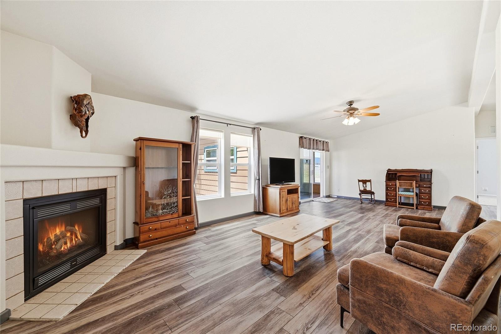 20300 Old Ranch Loop Nathrop, CO 81236 - Photo 12 of 35 a living room with furniture a fireplace and a flat screen tv