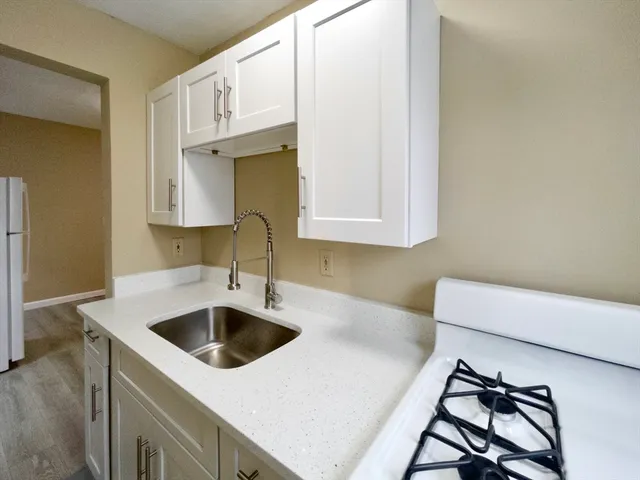 a kitchen with a sink and a stove top oven