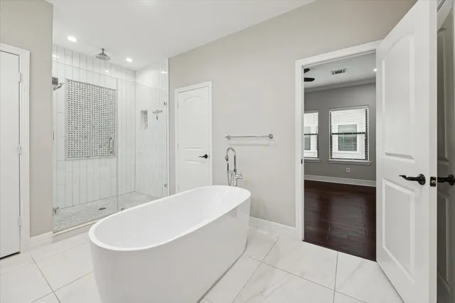 a bathroom with a bathtub and a shower