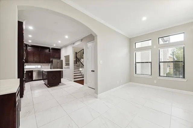 a kitchen with stainless steel appliances kitchen island granite countertop a sink and cabinets