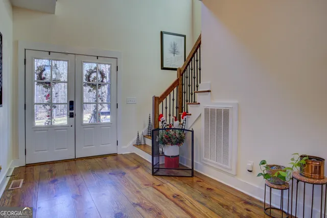a living room with furniture or wooden floor and a large window