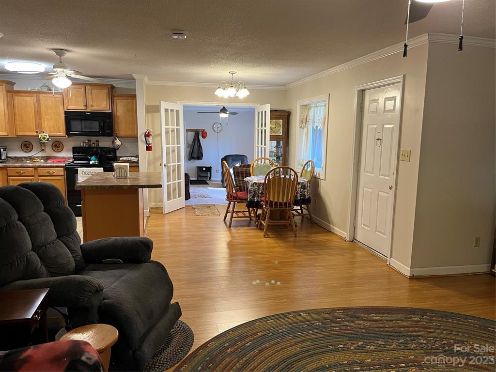 120 Barlow Lane Salisbury, NC 28147 - Photo 19 of 34 a living room with furniture wooden floor and a view of kitchen