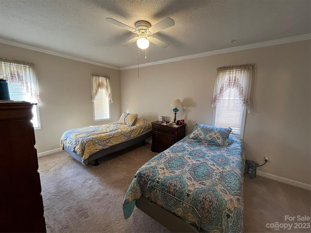 120 Barlow Lane Salisbury, NC 28147 - Photo 30 of 34 a bedroom with two beds and a chandelier