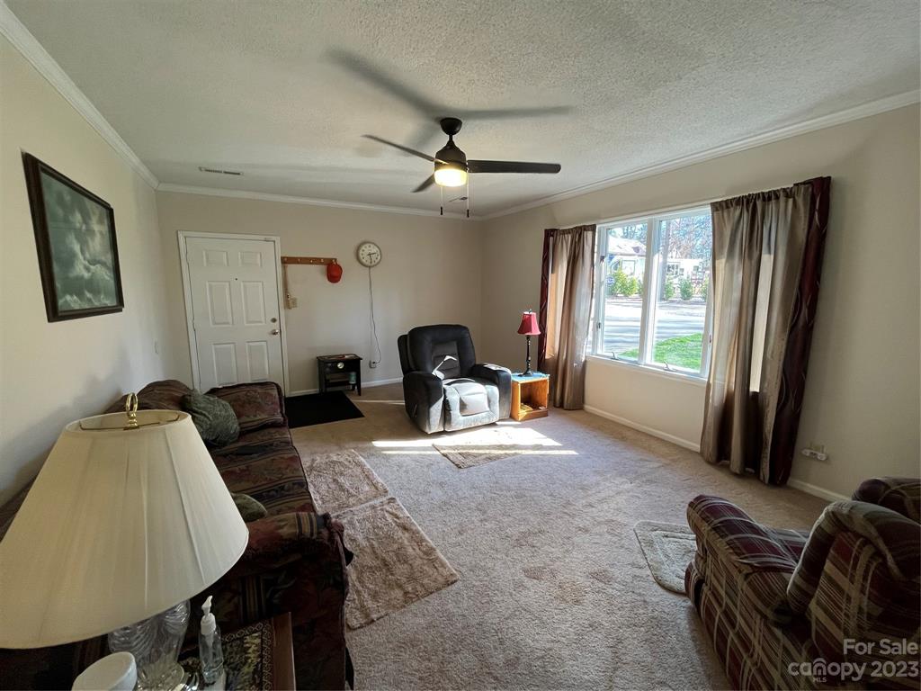 120 Barlow Lane Salisbury, NC 28147 - Photo 10 of 34 a living room with furniture a large window and gym equipment