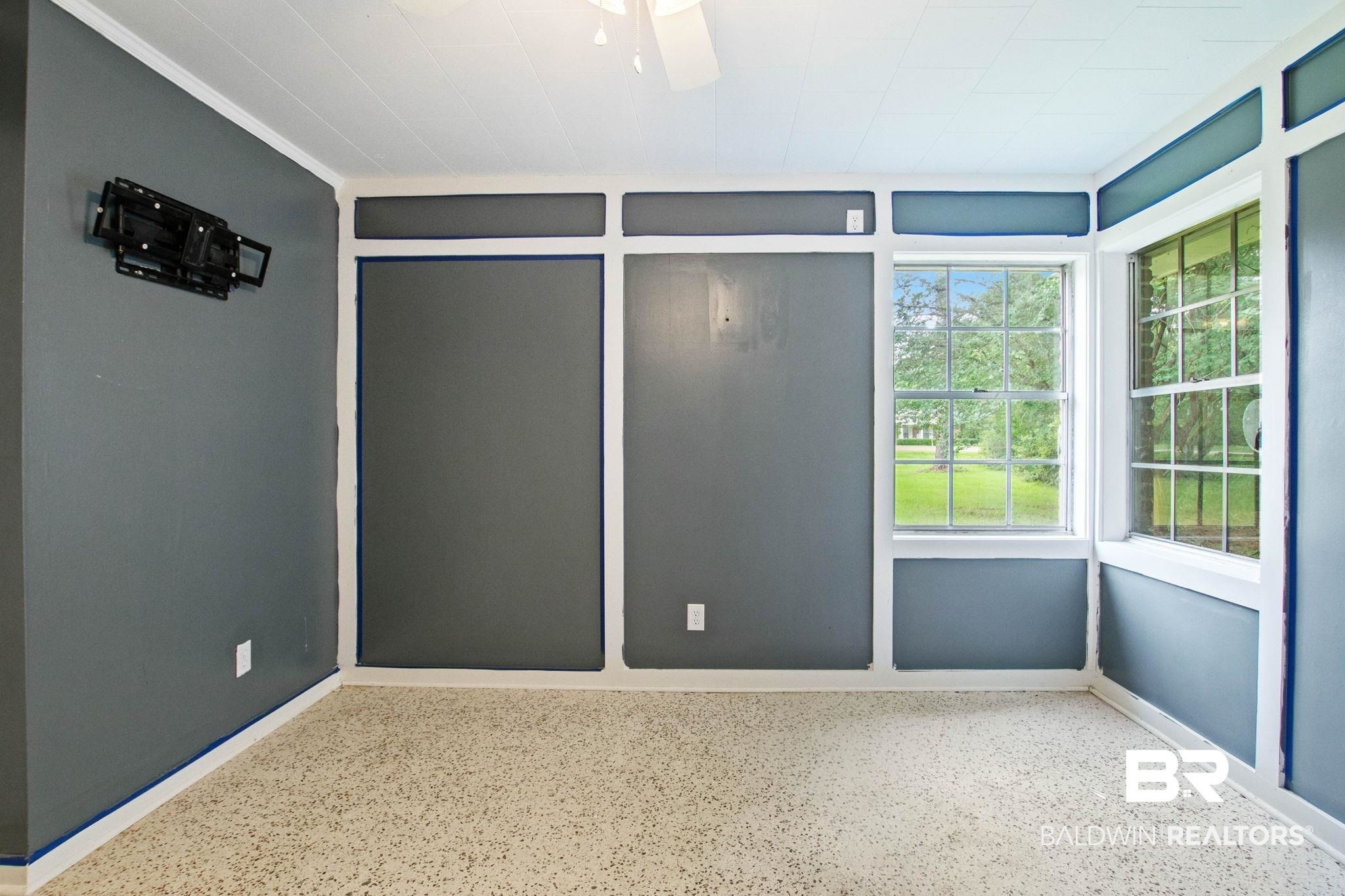 384 Old Bratt Road Atmore, AL 36502 - Photo 46 of 64 Room featuring paneled accent walls with a neutral gray finish, white trim, and a white beadboard ceiling