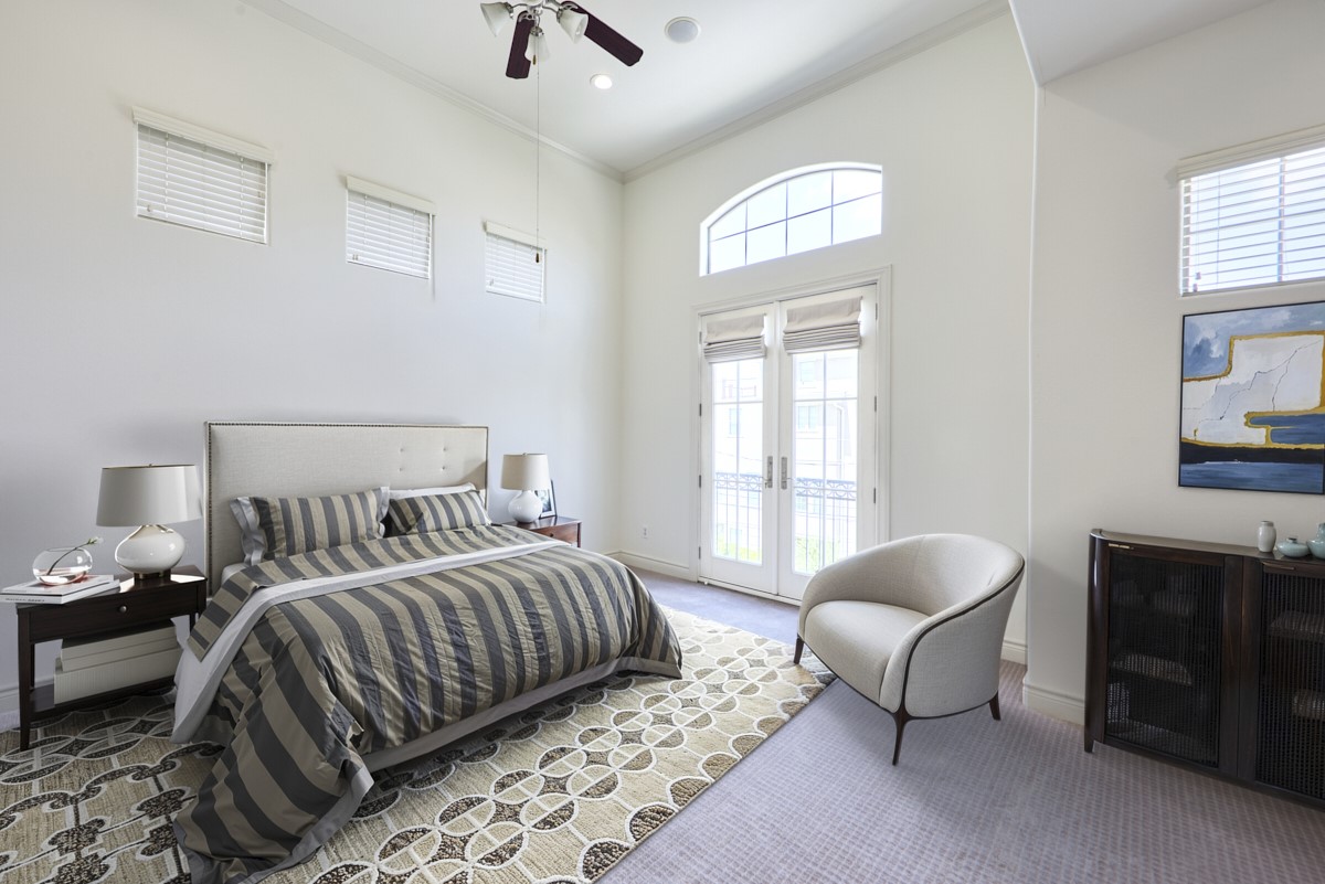 1026 Wagner Street Houston, TX 77007 - Photo 18 of 33 a bedroom with a bed a chandelier and a window