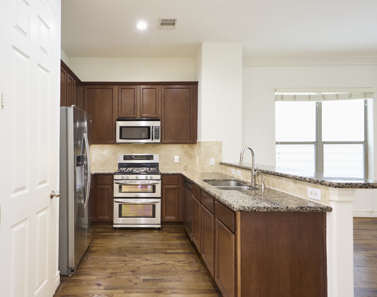 1026 Wagner Street Houston, TX 77007 - Photo 4 of 33 a kitchen with stainless steel appliances granite countertop a sink stove and refrigerator