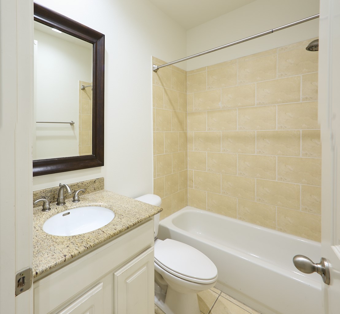 1026 Wagner Street Houston, TX 77007 - Photo 7 of 33 a bathroom with a granite countertop sink toilet and shower