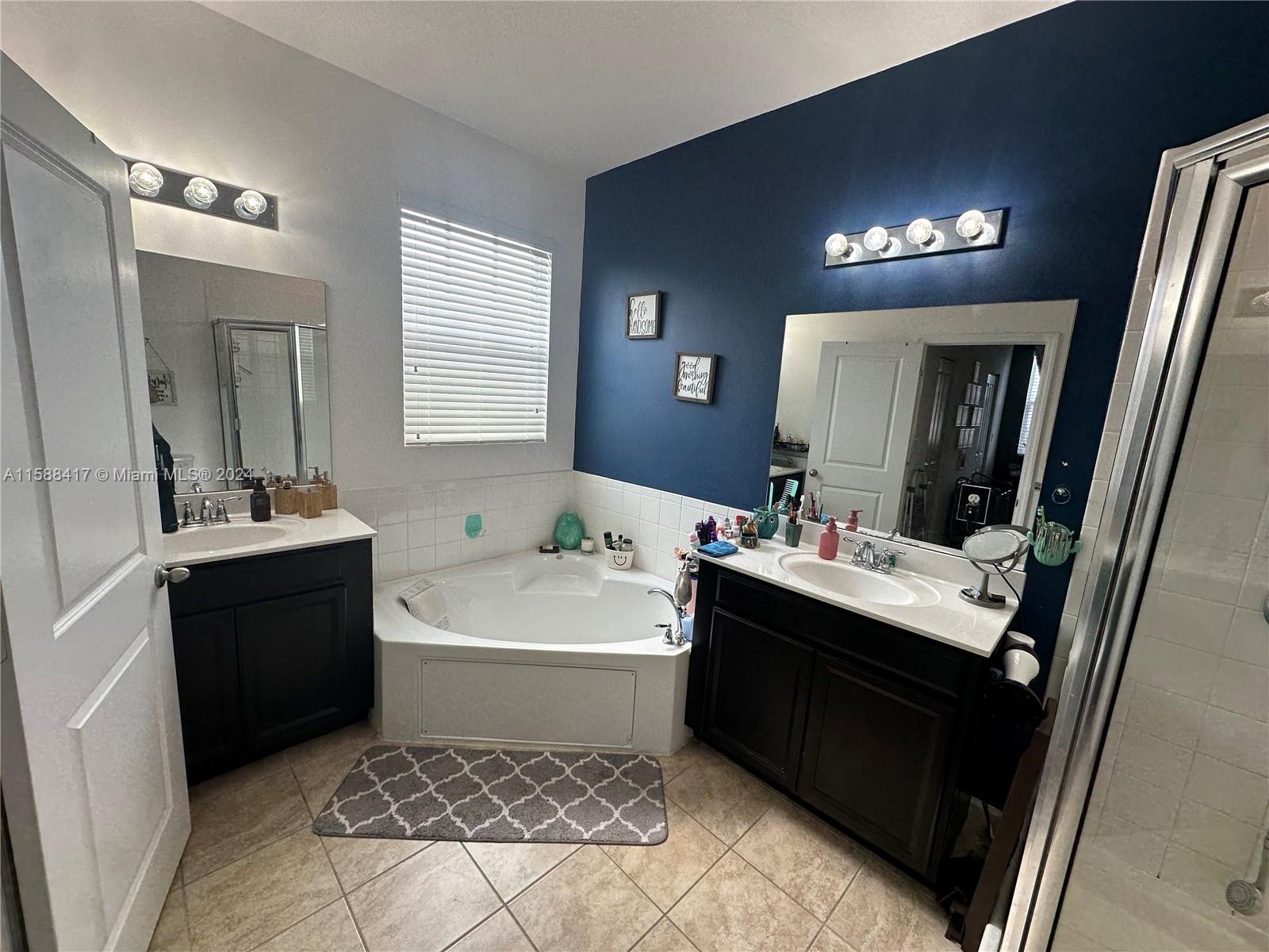 11606 Southwest 245 Terrace Homestead, FL 33032 - Photo 19 of 27 a bathroom with a sink vanity and mirror