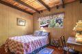 25075 Wood Road Idyllwild, CA 92549 - Photo 17 of 21 a bedroom with a bed and a view of backyard