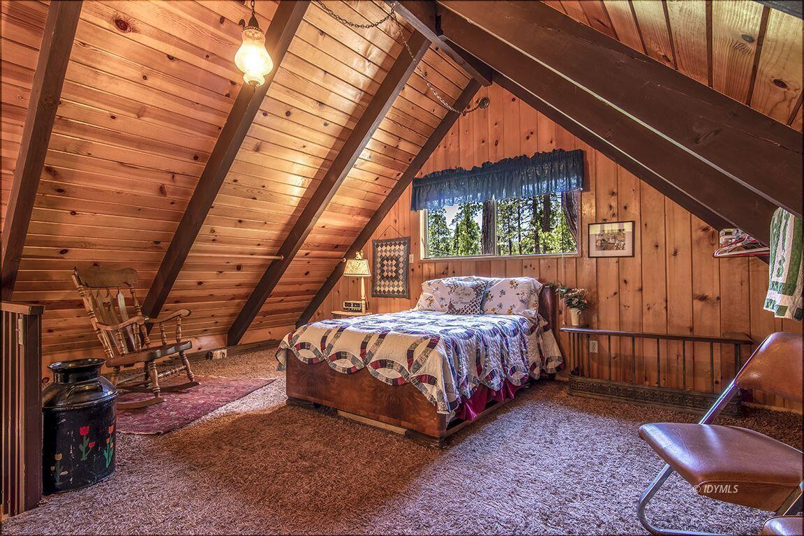 25075 Wood Road Idyllwild, CA 92549 - Photo 21 of 21 a bed sitting in a room next to a window