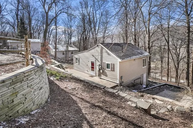 a white house that has a tree in front of it
