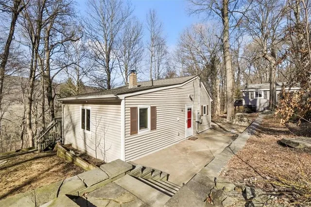 a view of a house with a yard covered in snow