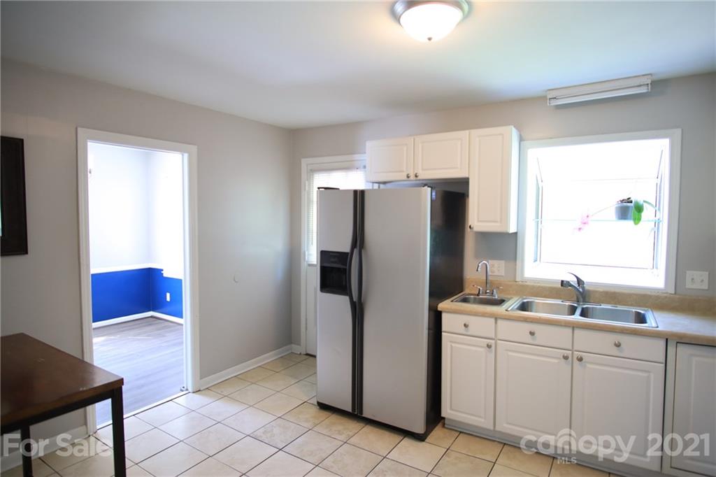 433 Willow Road Salisbury, NC 28147 - Photo 13 of 34 a kitchen with a refrigerator sink and cabinets