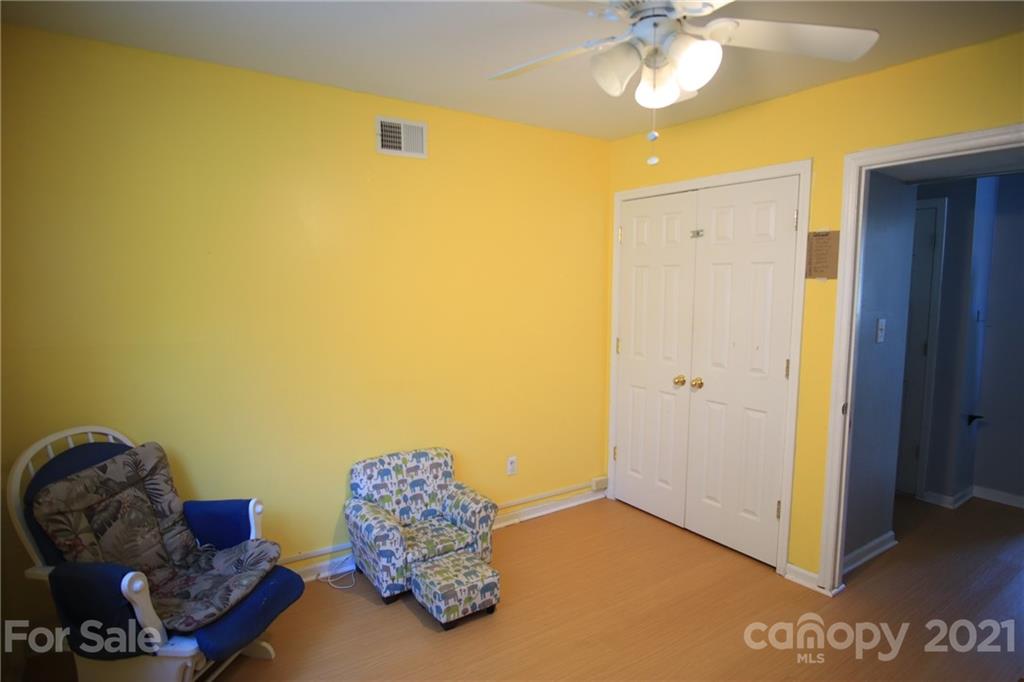 433 Willow Road Salisbury, NC 28147 - Photo 28 of 34 a bedroom with a bed and a chandelier
