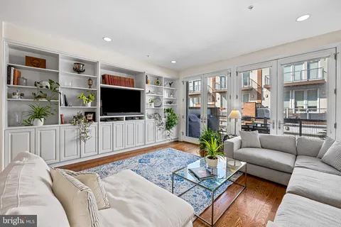 a bathroom with a sink a mirror a vanity and a shower