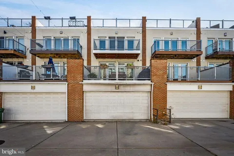 a kitchen with stainless steel appliances kitchen island granite countertop a table chairs in it and wooden floors