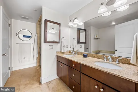 a spacious bedroom with a bed and a flat screen tv