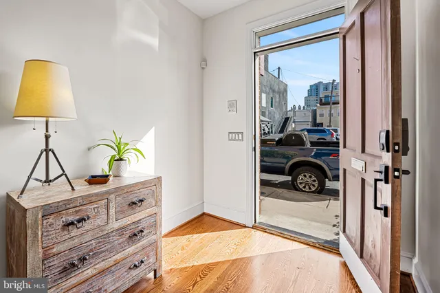 a view of entryway and hall with wooden floor