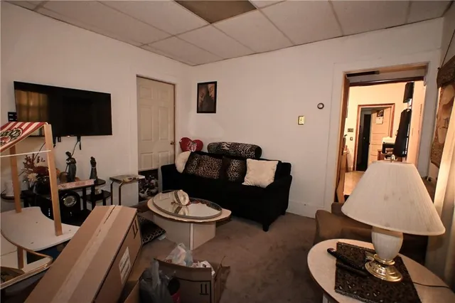 a living room with furniture a lamp and a flat screen tv