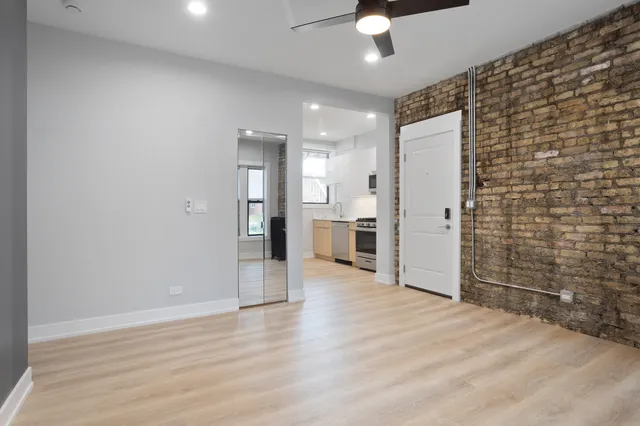 a view of a kitchen with a refrigerator and a stove top oven