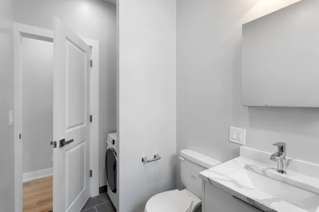 a bathroom with a sink a toilet and a mirror