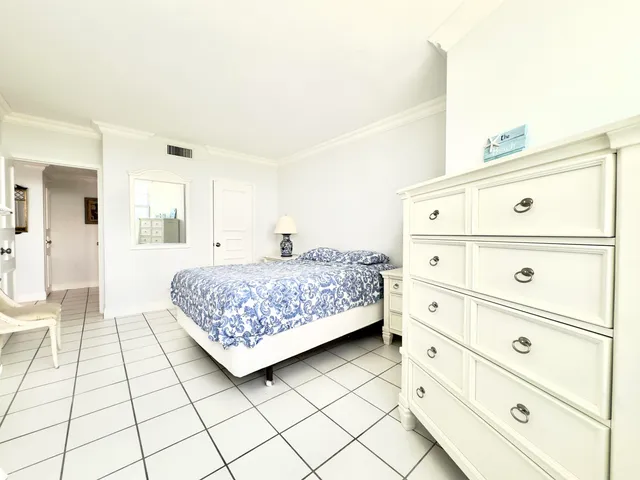 a bedroom with a bed and a mirror