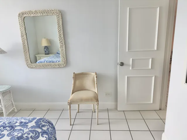 a living room with a mirror and a table