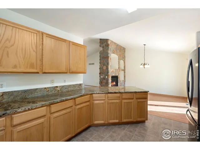 a kitchen with stainless steel appliances granite countertop a sink a stove and a refrigerator