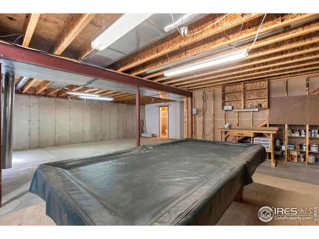 a living room with a bed furniture and a large window