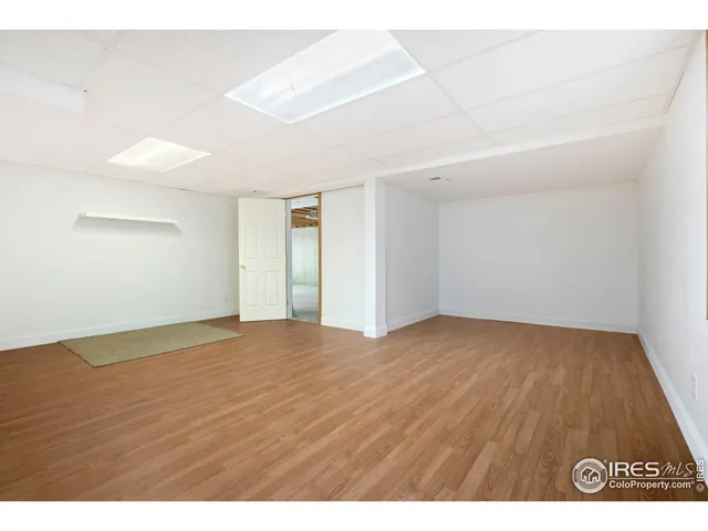 a view of an empty room and wooden floor