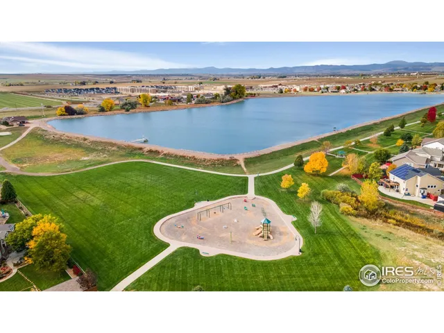 a park view with a bench and lake view