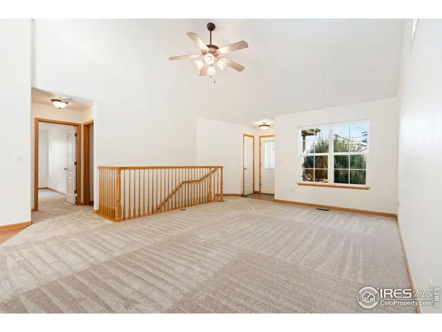 a view of a livingroom with a ceiling fan and window