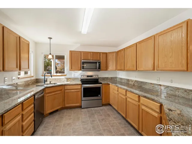 a kitchen with stainless steel appliances granite countertop a stove sink and cabinets
